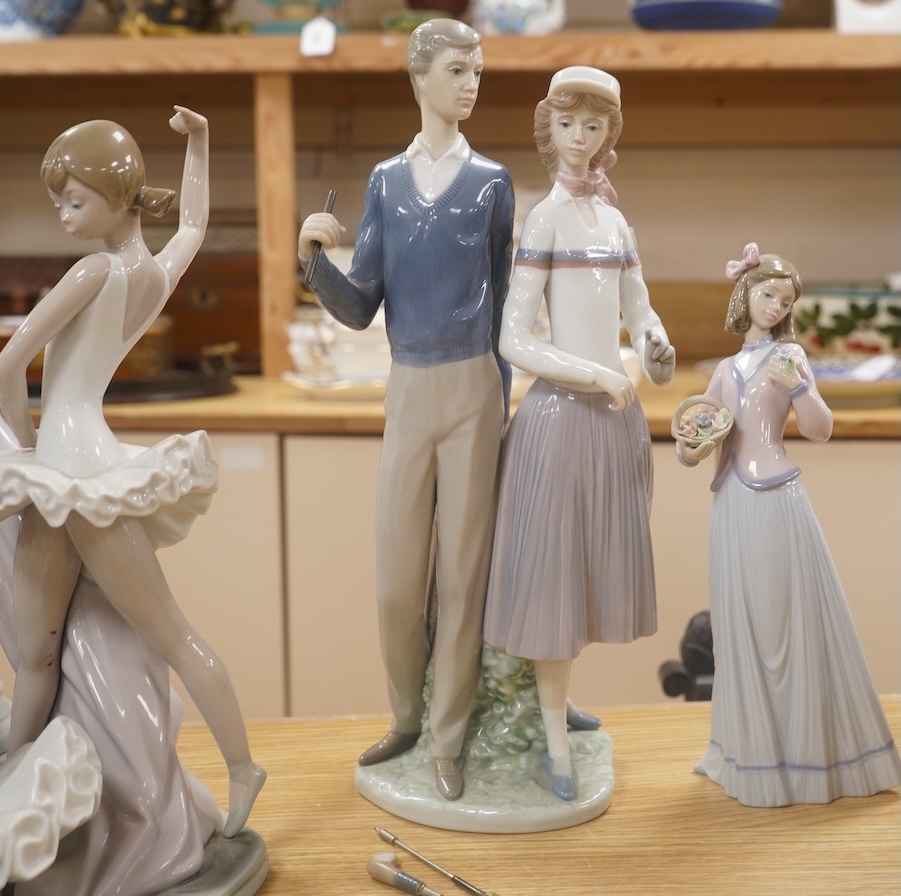 A large Lladro figure group of three ballet dancers by a tall floral column and eight other Lladro figures including a model of a bell. Tallest figure group 45cm high. Condition - golfer group, golf clubs broken.